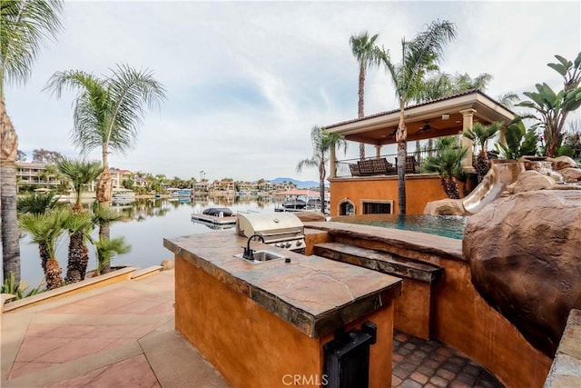 23180 Gray Fox Dr, Canyon Lake, CA 92587 - view of patio / terrace with an outdoor kitchen, grilling area, a water view, ceiling fan, and a balcony