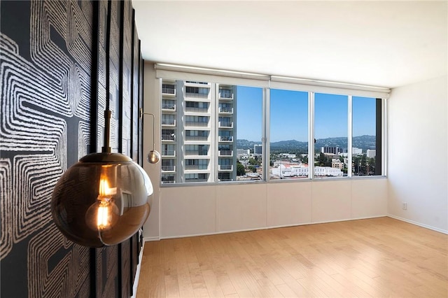 empty room with wood finished floors and a city view