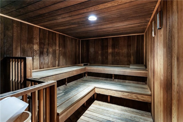 relaxing sauna / steam room with wood ceiling and wood walls