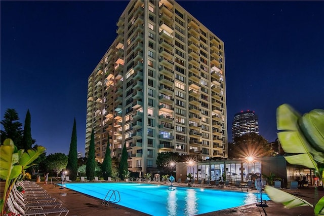 pool at twilight featuring a community pool