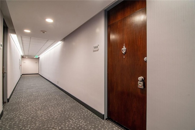 corridor with carpet floors, baseboards, and recessed lighting