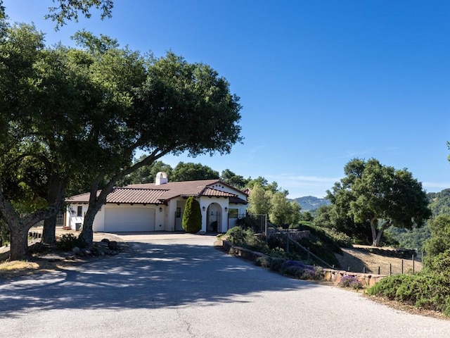 14800 Santa Ana Rd, Atascadero, CA 93422 - mediterranean / spanish house with a garage, driveway, stucco siding, a chimney, and a tiled roof
