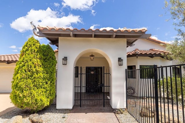 14800 Santa Ana Rd, Atascadero, CA 93422 - property entrance with a tile roof, stucco siding, and a gate