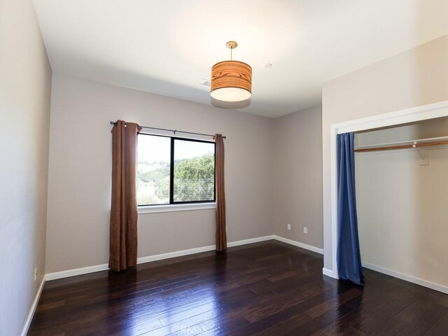 14800 Santa Ana Rd, Atascadero, CA 93422 - unfurnished bedroom featuring hardwood / wood-style floors, a closet, and baseboards
