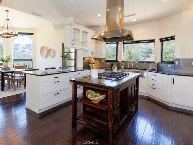 14800 Santa Ana Rd, Atascadero, CA 93422 - kitchen with dark countertops, island range hood, stainless steel gas cooktop, dark wood finished floors, and recessed lighting