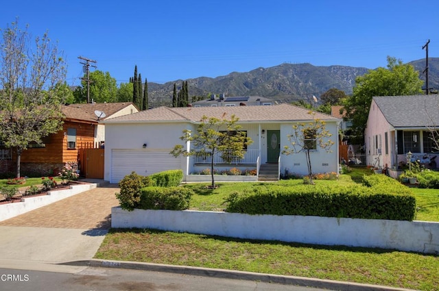 3749 Fairesta St, La Crescenta, CA 91214 - ranch-style home with an attached garage, a mountain view, decorative driveway, and a front lawn