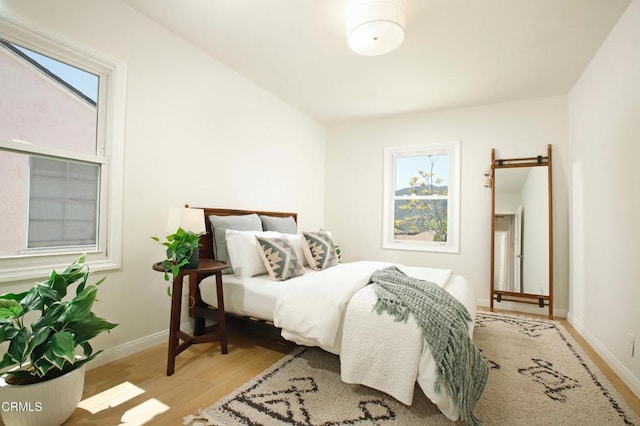 3749 Fairesta St, La Crescenta, CA 91214 - bedroom featuring a barn door, wood finished floors, baseboards, and multiple windows