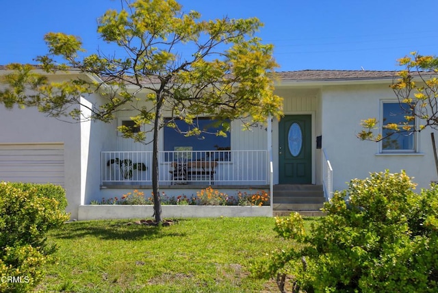 3749 Fairesta St, La Crescenta, CA 91214 - property entrance featuring a yard, stucco siding, and covered porch