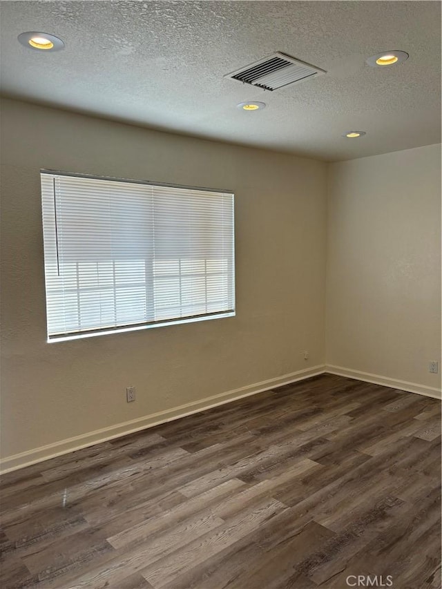 6688 Yucca Ave Unit 29, Palms, CA 92277 - unfurnished room with dark wood-style flooring, recessed lighting, a textured ceiling, and baseboards