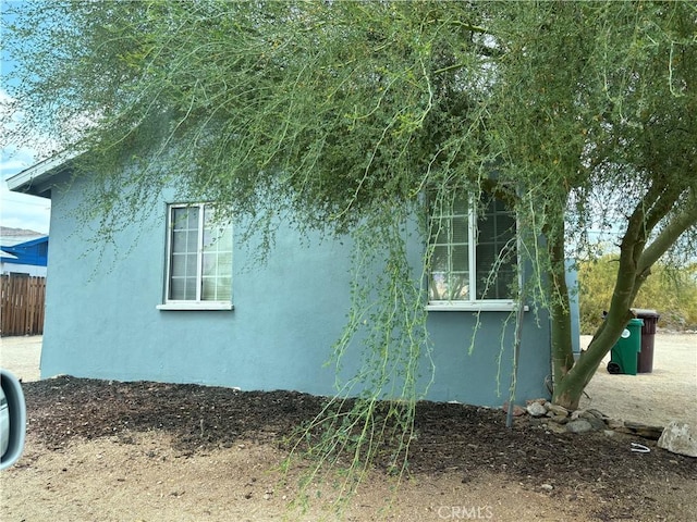 6688 Yucca Ave Unit 29, Palms, CA 92277 - view of property exterior featuring stucco siding and fence
