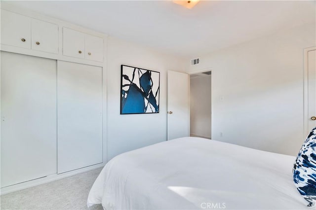 carpeted bedroom with a closet