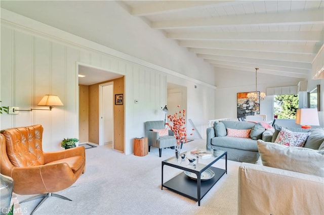 carpeted living area with a chandelier