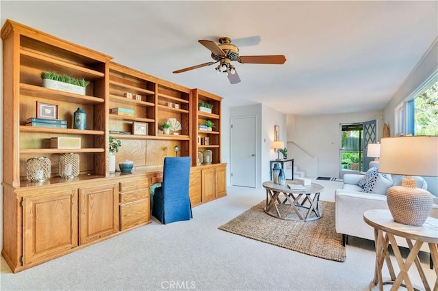 sitting room with light colored carpet and ceiling fan