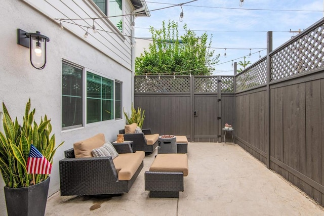 view of patio / terrace with fence, a gate, and an outdoor fire pit