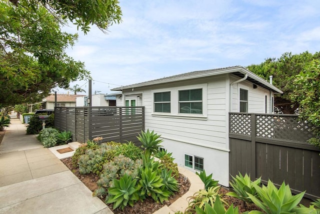 view of side of home with fence