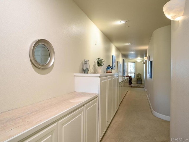 1099 1st St Unit 217, Coronado, CA 92118 - hall featuring light colored carpet, baseboards, and an upstairs landing