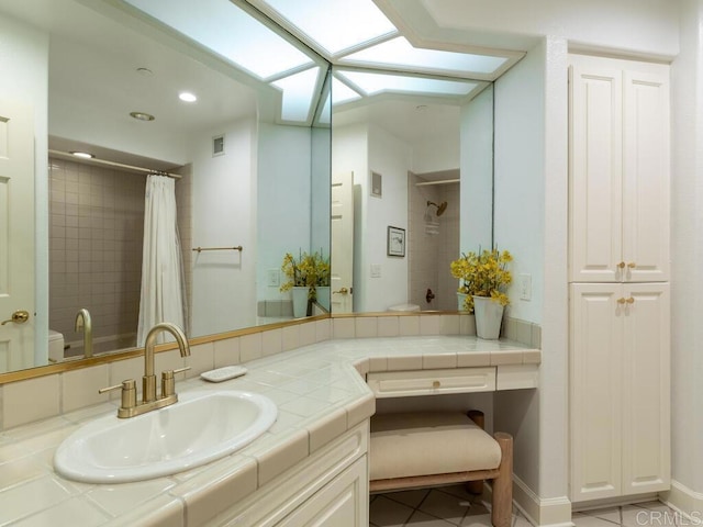 1099 1st St Unit 217, Coronado, CA 92118 - bathroom with a shower with curtain, vanity, recessed lighting, a skylight, and toilet