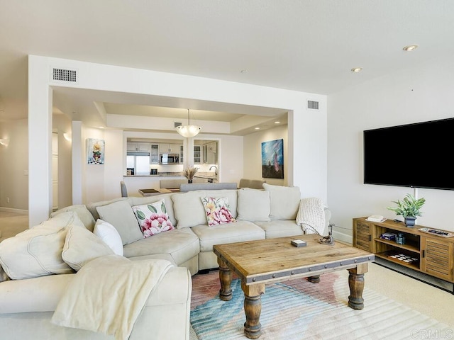 1099 1st St Unit 217, Coronado, CA 92118 - living area with baseboards, a raised ceiling, and recessed lighting