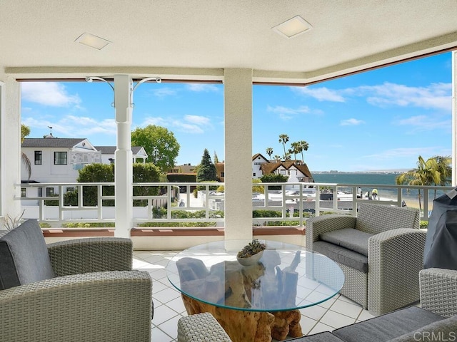 1099 1st St Unit 217, Coronado, CA 92118 - sunroom with tile patterned floors, a water view, plenty of natural light, and a textured ceiling