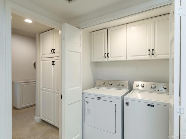 1099 1st St Unit 217, Coronado, CA 92118 - laundry room featuring cabinet space, independent washer and dryer, light colored carpet, and recessed lighting