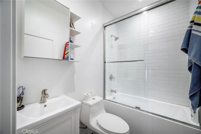 full bath featuring combined bath / shower with glass door, vanity, and toilet