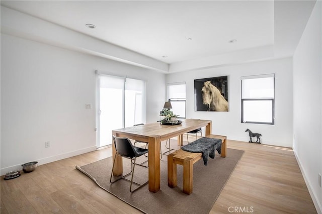 dining area with baseboards and light wood-type flooring