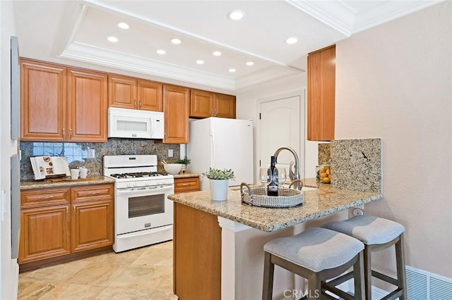 173 N Magnolia Ave Unit A, Anaheim, CA 92801 - kitchen with white appliances, decorative backsplash, a raised ceiling, crown molding, and a peninsula