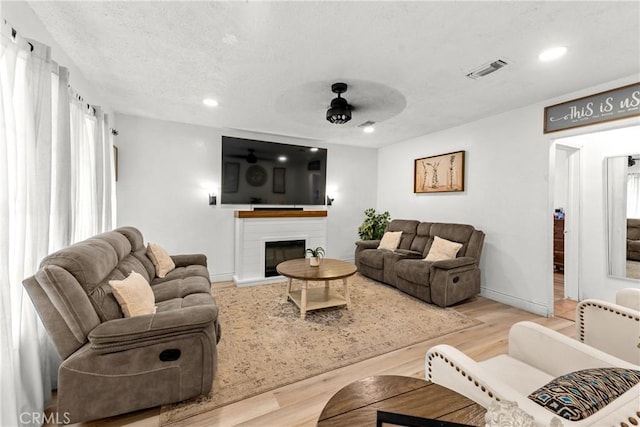 115 N Magnolia Ct, Compton, CA 90220 - living area featuring ceiling fan, wood finished floors, recessed lighting, a fireplace with raised hearth, and baseboards