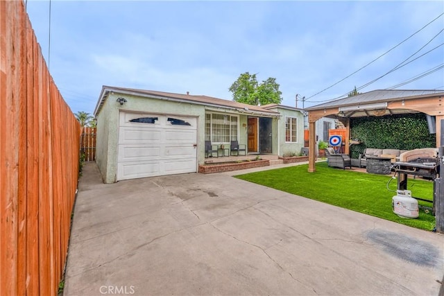 115 N Magnolia Ct, Compton, CA 90220 - view of front of home featuring an outdoor living space, concrete driveway, a garage, and stucco siding