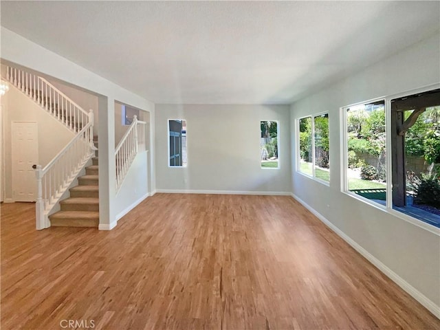 8424 Monique Ct, Riverside, CA 92508 - unfurnished living room featuring baseboards, light wood-style flooring, and healthy amount of natural light