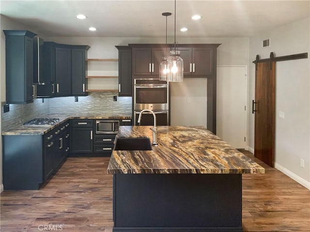8424 Monique Ct, Riverside, CA 92508 - kitchen featuring a sink, appliances with stainless steel finishes, a barn door, open shelves, and backsplash
