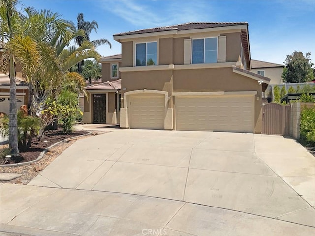 8424 Monique Ct, Riverside, CA 92508 - view of front of property with stucco siding, a garage, a tiled roof, concrete driveway, and a gate