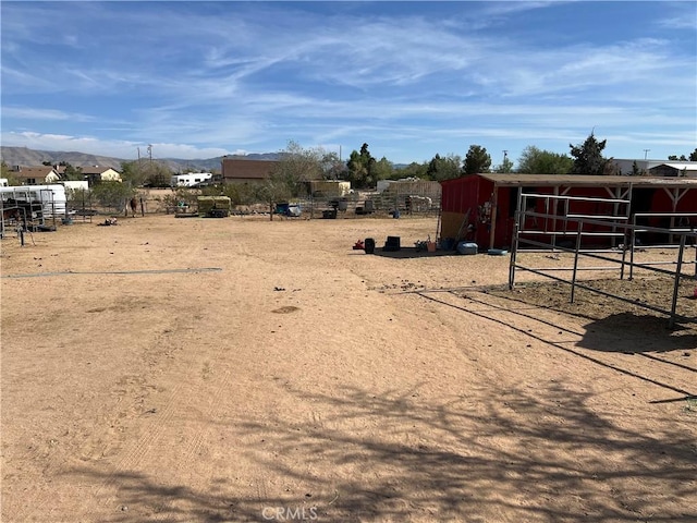 view of yard featuring an exterior structure, an outbuilding, and a mountain view