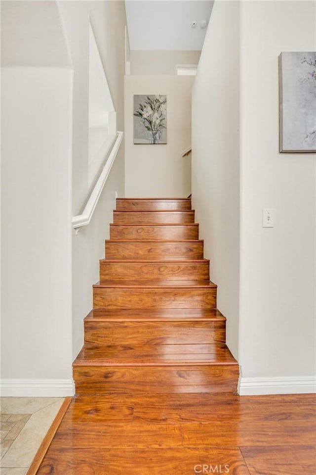 870 E Bermuda Dunes Ct, Ontario, CA 91761 - stairway featuring wood finished floors and baseboards