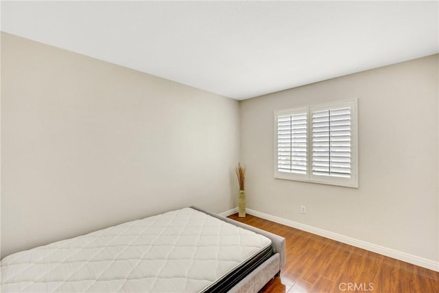 870 E Bermuda Dunes Ct, Ontario, CA 91761 - bedroom featuring baseboards and wood finished floors