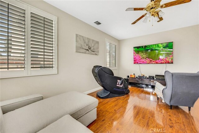 870 E Bermuda Dunes Ct, Ontario, CA 91761 - living room with wood finished floors, a ceiling fan, and baseboards
