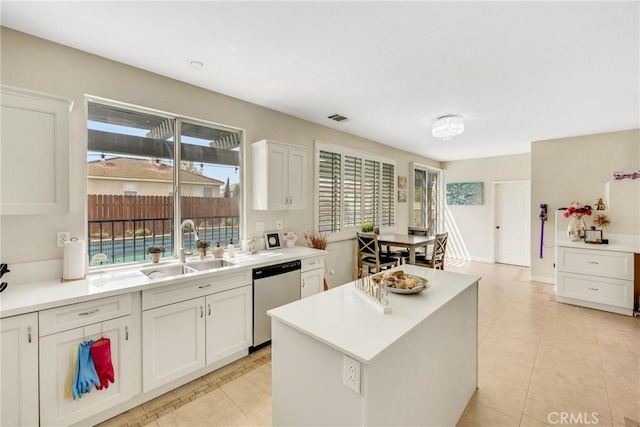 870 E Bermuda Dunes Ct, Ontario, CA 91761 - kitchen with dishwasher, a sink, light tile patterned flooring, white cabinets, and light countertops