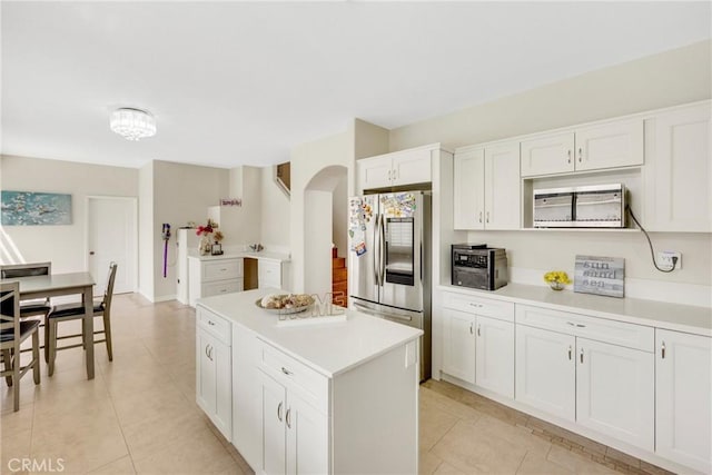 870 E Bermuda Dunes Ct, Ontario, CA 91761 - kitchen with smart refrigerator, light tile patterned floors, light countertops, and white cabinets