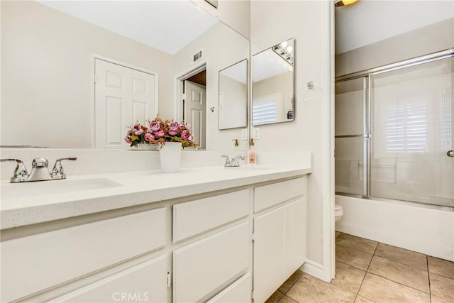 870 E Bermuda Dunes Ct, Ontario, CA 91761 - bathroom with toilet, double vanity, tile patterned floors, and enclosed tub / shower combo