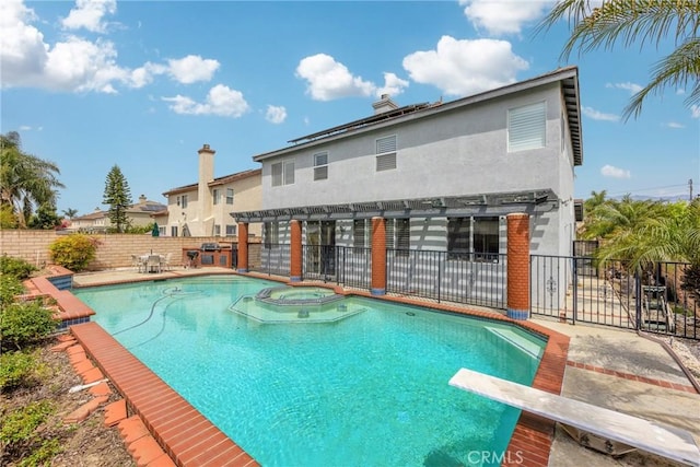 870 E Bermuda Dunes Ct, Ontario, CA 91761 - view of pool with a pool with connected hot tub, a patio area, a fenced backyard, and a diving board