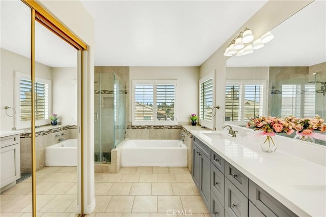 870 E Bermuda Dunes Ct, Ontario, CA 91761 - bathroom with vanity, a bath, a shower stall, and tile patterned floors