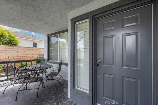 870 E Bermuda Dunes Ct, Ontario, CA 91761 - property entrance with outdoor dining space and fence