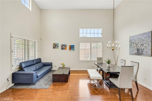870 E Bermuda Dunes Ct, Ontario, CA 91761 - living area featuring a high ceiling, a chandelier, plenty of natural light, and wood finished floors