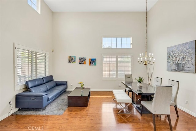 870 E Bermuda Dunes Ct, Ontario, CA 91761 - living room with a high ceiling, a chandelier, plenty of natural light, and wood finished floors
