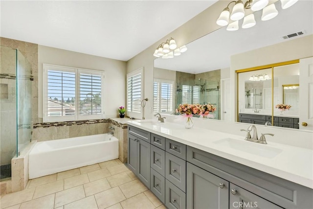 870 E Bermuda Dunes Ct, Ontario, CA 91761 - full bathroom with a chandelier, a stall shower, double vanity, a garden tub, and tile patterned flooring