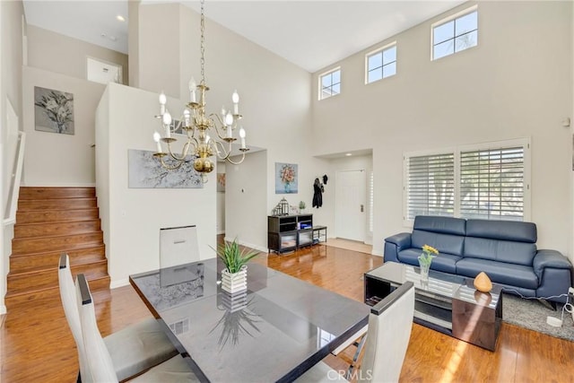 870 E Bermuda Dunes Ct, Ontario, CA 91761 - dining space with a high ceiling, wood finished floors, stairway, and a chandelier