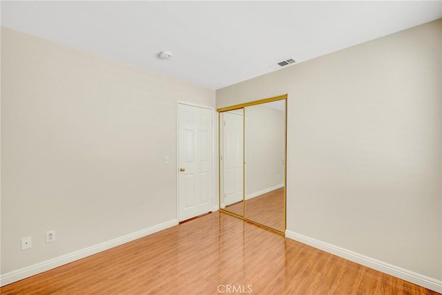870 E Bermuda Dunes Ct, Ontario, CA 91761 - unfurnished bedroom with baseboards, wood finished floors, and a closet