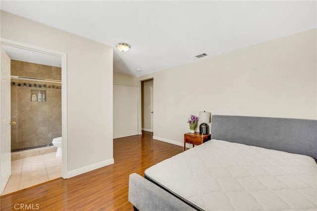 870 E Bermuda Dunes Ct, Ontario, CA 91761 - bedroom with wood finished floors, baseboards, and ensuite bathroom