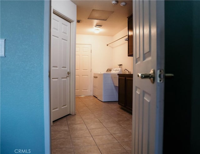 25657 Tamarisk St, Barstow, CA 92311 - washroom with cabinet space, washer and clothes dryer, and light tile patterned flooring