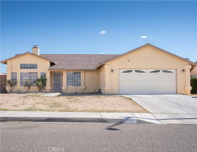 25657 Tamarisk St, Barstow, CA 92311 - ranch-style house with stucco siding, concrete driveway, an attached garage, and a chimney